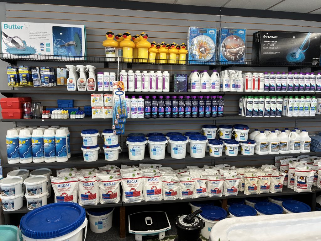 Store shelves stocked with pool chemicals and accessories, supporting supplies for hot tubs in Topeka.